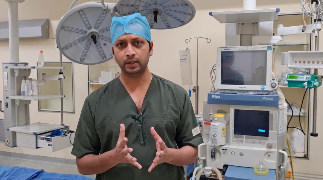 Dr. Nitin Shrivastava explaining a CT scan to a patient during an ICU consultation
