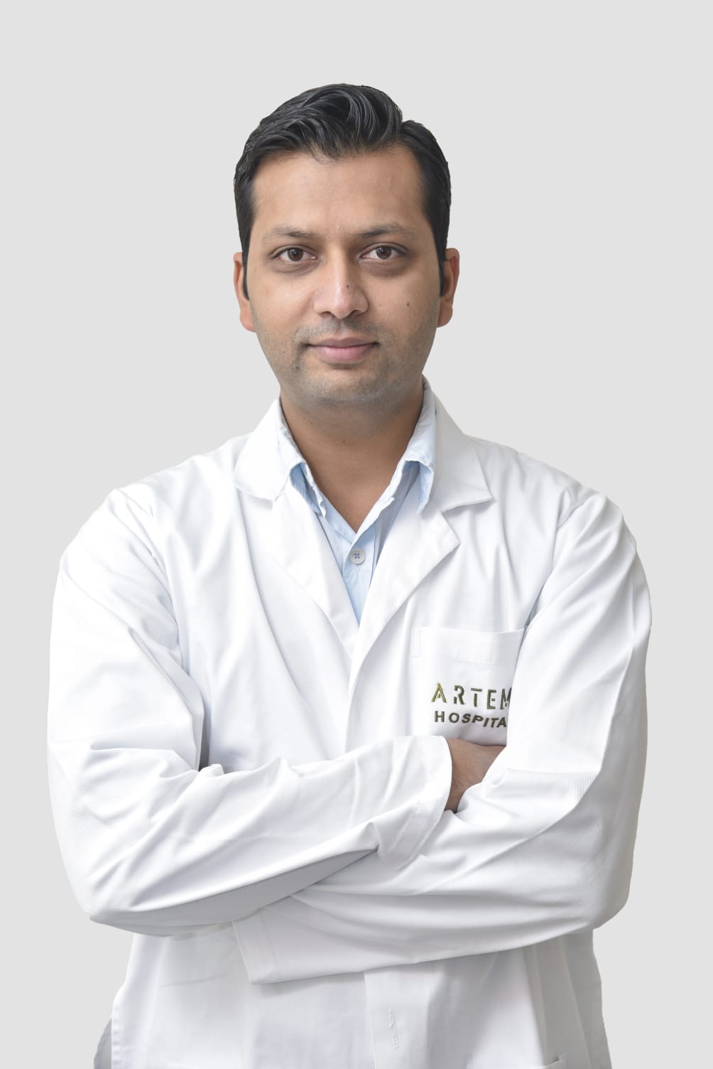Portrait of Dr. Nitin Shrivastava in clinical coat - Senior Urologist & Uro-Oncologist